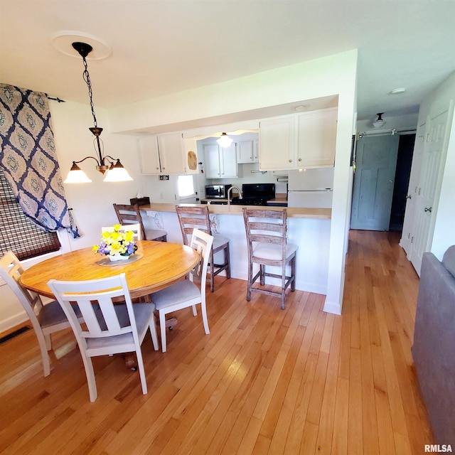 dining space with light hardwood / wood-style flooring