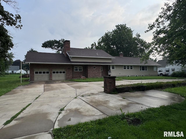 ranch-style house featuring a garage and a front yard