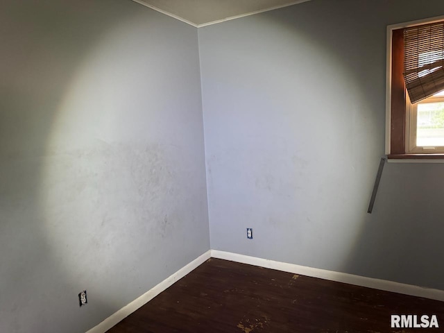 unfurnished room with dark wood-type flooring