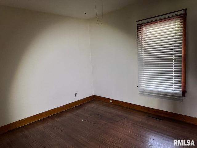 spare room featuring dark hardwood / wood-style flooring