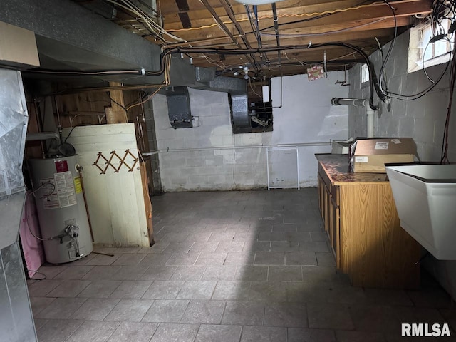 basement with water heater and sink