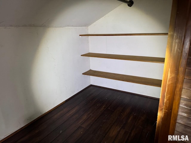 stairs with vaulted ceiling and hardwood / wood-style floors