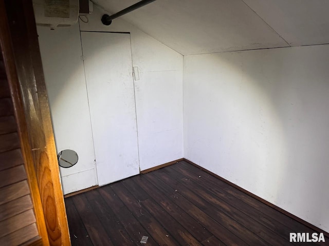 unfurnished room with lofted ceiling and hardwood / wood-style floors