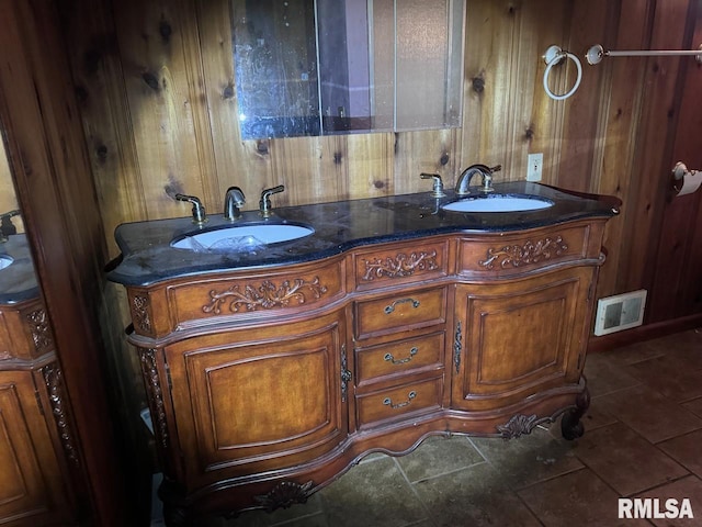 bathroom with vanity, wooden walls, and tile patterned floors