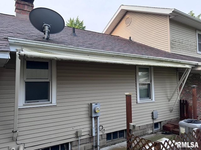 view of side of property with central air condition unit