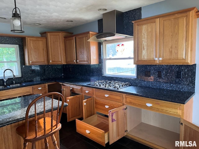 kitchen featuring island exhaust hood, decorative backsplash, gas stovetop, and dark tile patterned floors