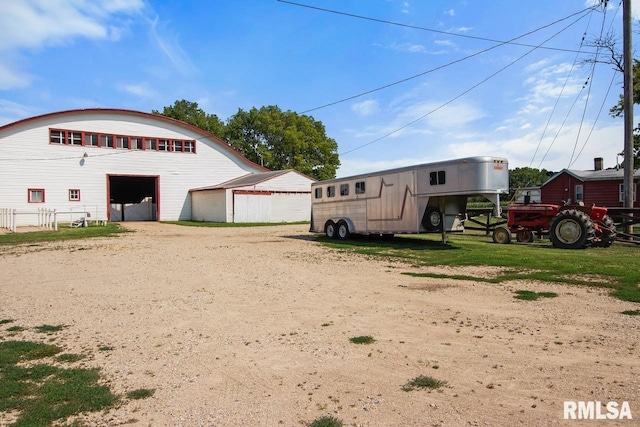 exterior space featuring a garage and an outbuilding