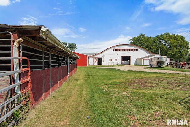 view of yard featuring an outbuilding and a garage