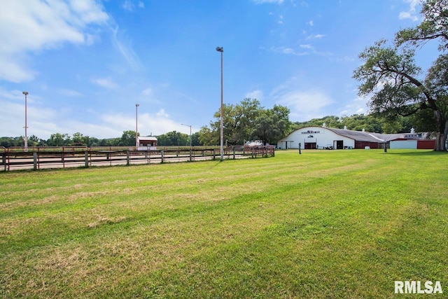 view of yard featuring fence and a rural view