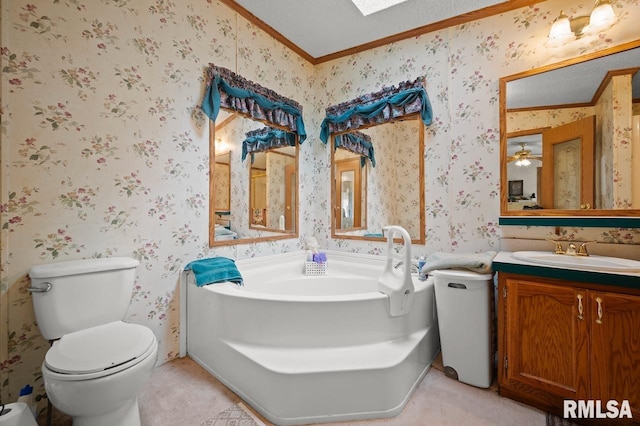 bathroom with ceiling fan, a textured ceiling, vanity, and toilet