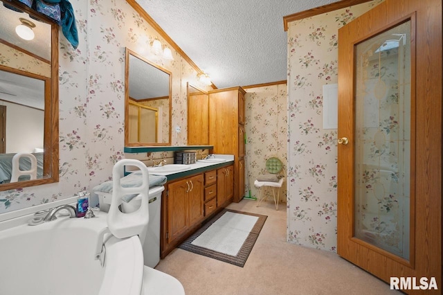 bathroom featuring a tub, a textured ceiling, and dual bowl vanity