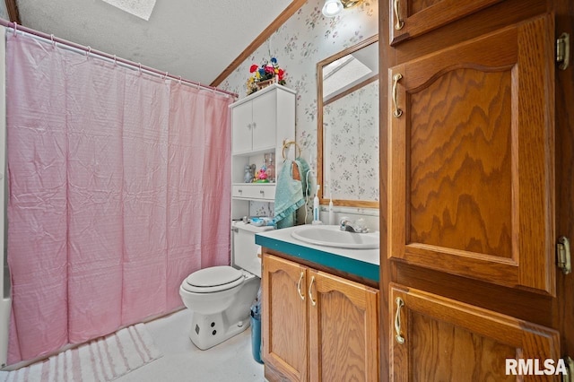 bathroom with vanity, toilet, a textured ceiling, wallpapered walls, and shower / bath combo