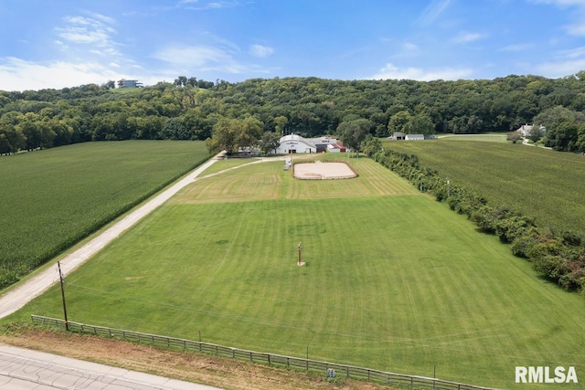 drone / aerial view with a wooded view and a rural view