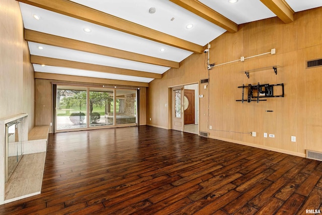 unfurnished living room with high vaulted ceiling, dark hardwood / wood-style floors, beam ceiling, and wood walls