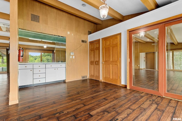 interior space featuring beamed ceiling and dark hardwood / wood-style floors