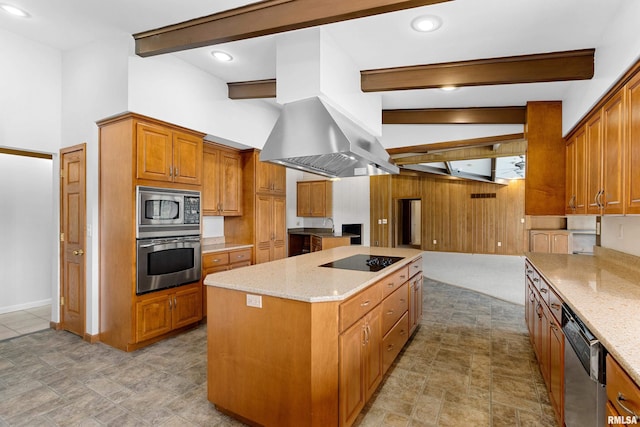 kitchen with appliances with stainless steel finishes, a center island, light stone counters, island exhaust hood, and beamed ceiling