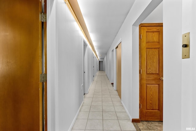 hall featuring light tile patterned floors