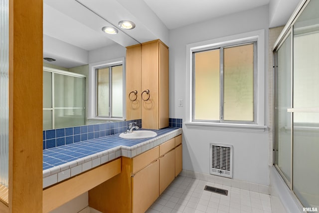 bathroom with vanity, tile patterned flooring, and shower / bath combination with glass door