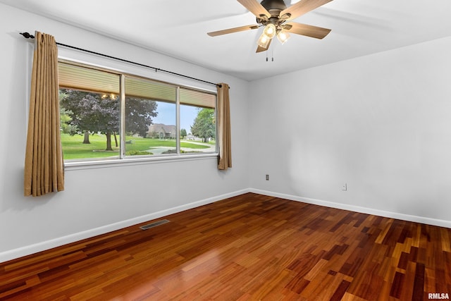 spare room with hardwood / wood-style flooring and ceiling fan