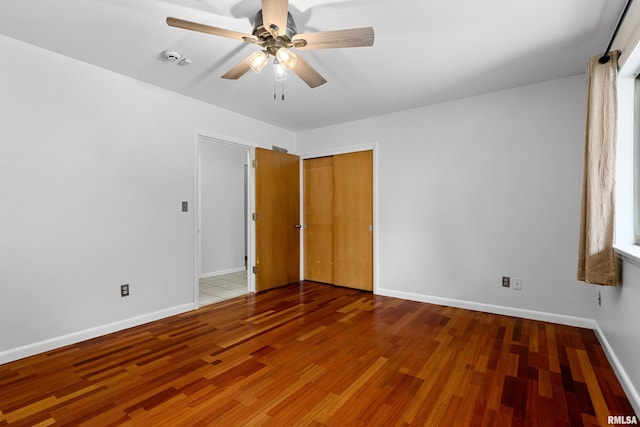 unfurnished room with hardwood / wood-style flooring and ceiling fan