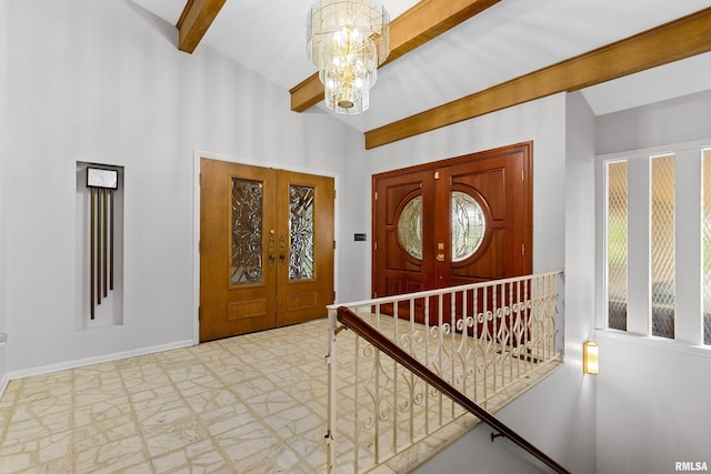 foyer featuring vaulted ceiling with beams, a wealth of natural light, a notable chandelier, and french doors