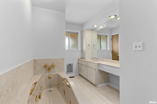 bathroom featuring tile patterned floors, vanity, and a washtub