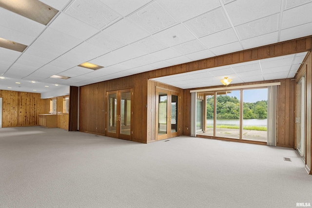 interior space featuring wooden walls and french doors