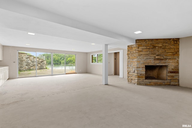 unfurnished living room with a stone fireplace