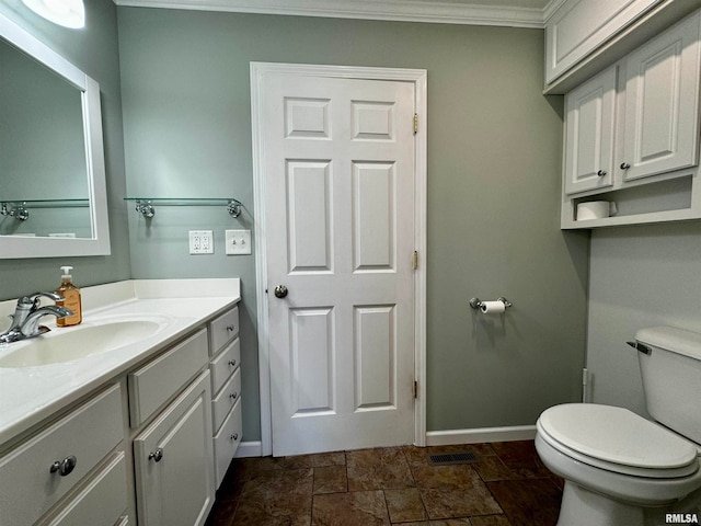 bathroom featuring vanity, ornamental molding, and toilet