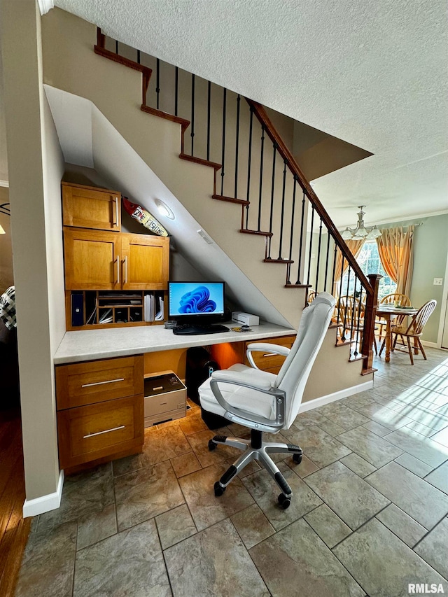 office area with a textured ceiling and built in desk