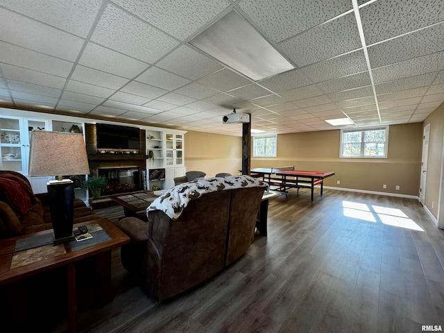 living room featuring hardwood / wood-style flooring and a drop ceiling