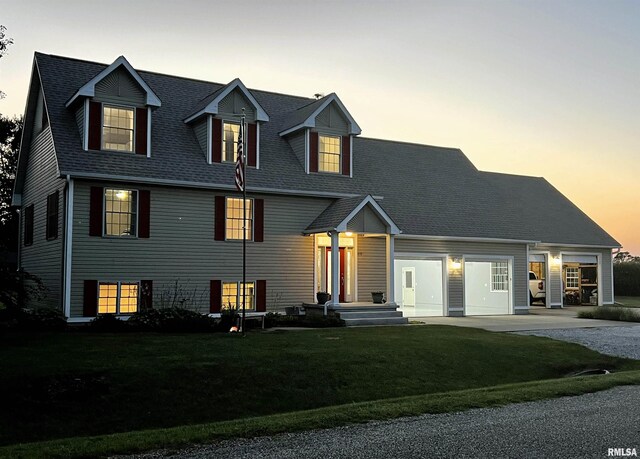 cape cod house featuring a yard