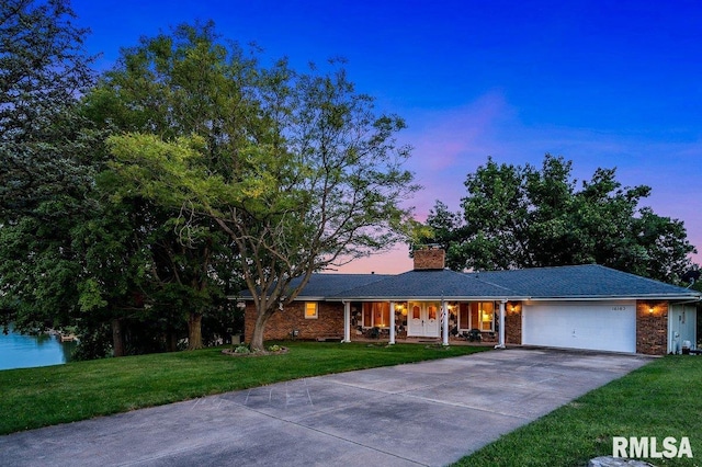 ranch-style house with a lawn and a garage