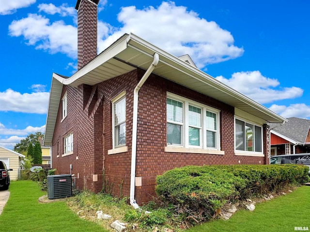 view of home's exterior featuring cooling unit and a yard