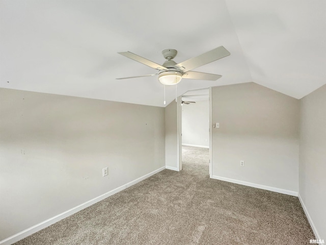 additional living space featuring carpet flooring, lofted ceiling, and ceiling fan