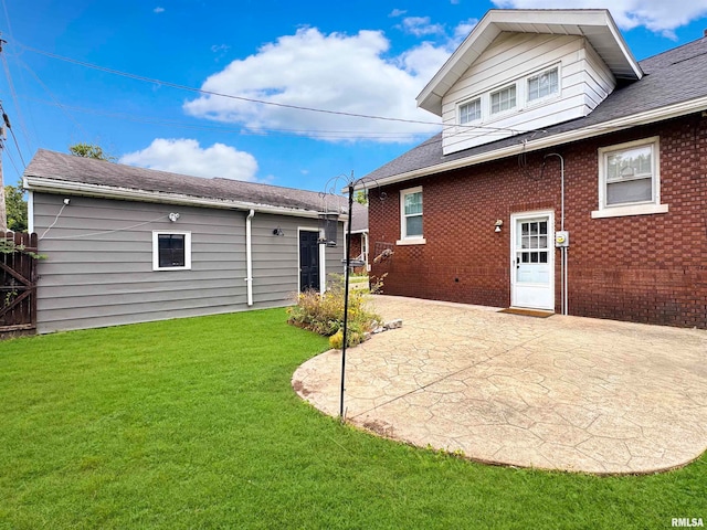 rear view of house with a patio and a yard