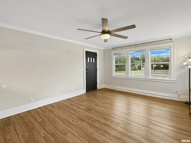 unfurnished room featuring a baseboard heating unit, ceiling fan, hardwood / wood-style floors, and crown molding