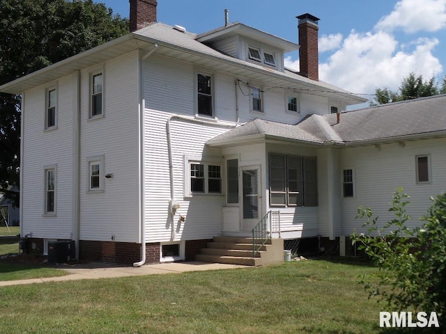 back of house with a lawn