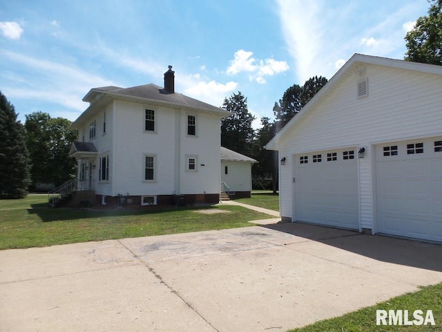 view of home's exterior with a garage and a lawn