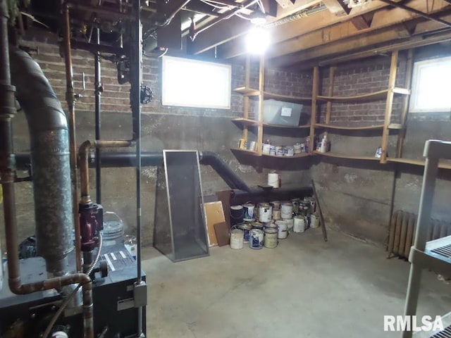 basement with a healthy amount of sunlight and radiator