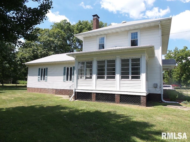 rear view of house with a yard