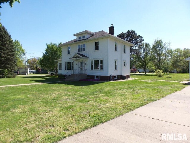 1201 Old Indiantown Rd, Henry, IL 61537 - back of house featuring entry steps, a lawn, and a chimney