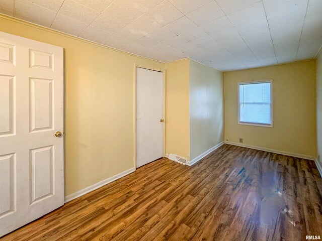 unfurnished room with hardwood / wood-style floors