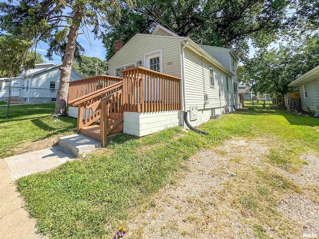 view of front of property with a deck and a front yard