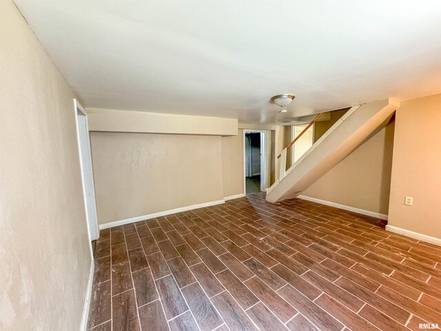 basement with dark hardwood / wood-style flooring