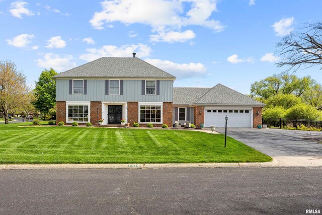 view of front of property with a garage and a front yard