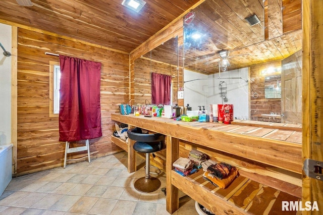 bar featuring wooden ceiling, wood walls, and tile patterned floors