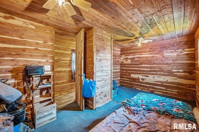 unfurnished bedroom featuring wood ceiling, wood walls, ceiling fan, and carpet