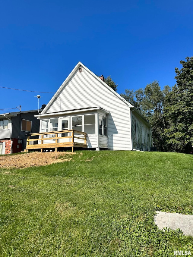 rear view of property with a lawn and a wooden deck