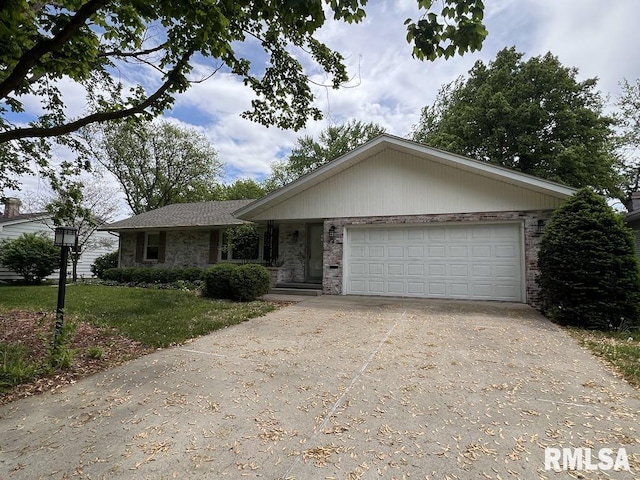 849 E Franklin St, Macomb, IL 61455 - single story home with brick siding, driveway, a garage, and a front yard